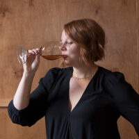 Portrait of Aria Dorsey drinking wine in Folk Nashville