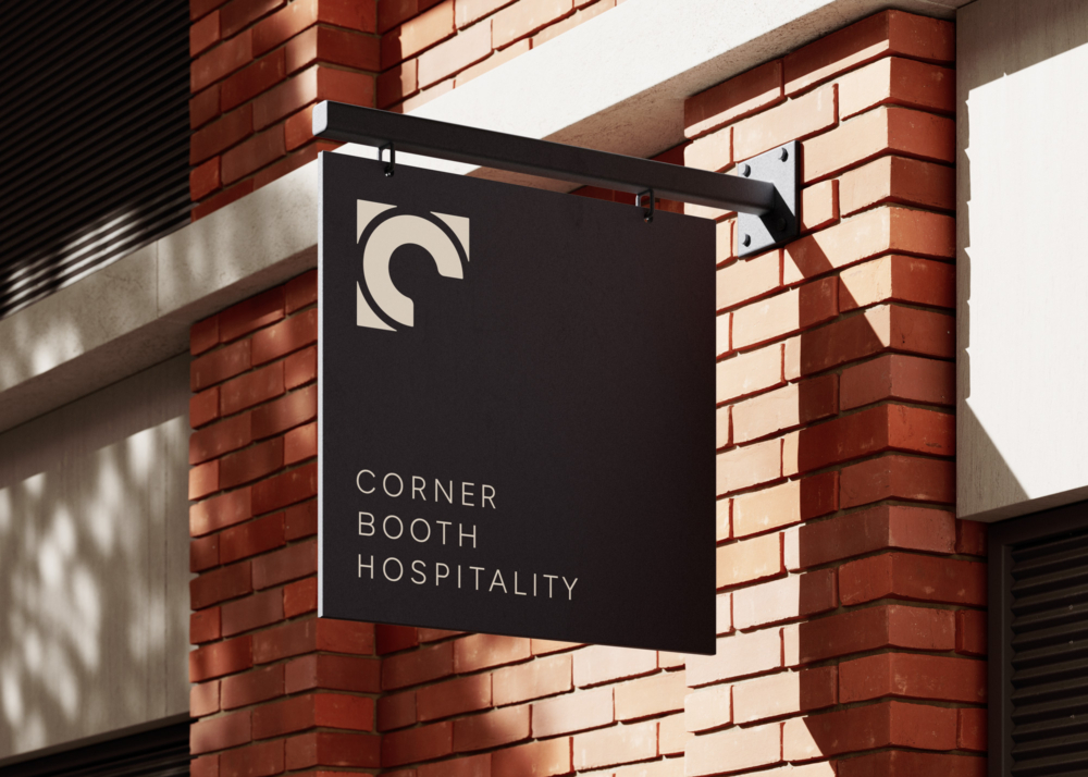 Corner Booth Hospitality logo treatment on a building's exterior signage
